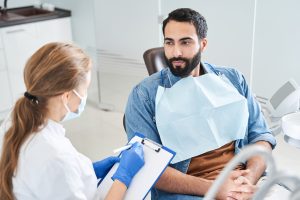 Man talking with his dentist about his Invisalign treatment.